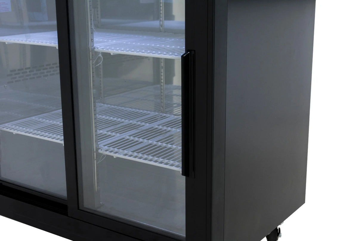Partial view of a commercial refrigeration unit with empty white wire shelves inside. The refrigerator has a black frame, vertical handle, and is set on wheels. The glass door reflects light, emphasizing its transparency—ideal for any back bar cooler setup.