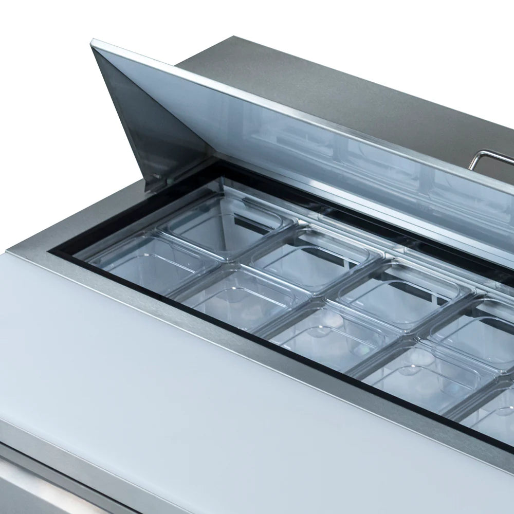 A close-up of an Empura Refrigeration Salad Prep Table with the lid open, revealing transparent rectangular containers arranged in rows inside for storing ingredients. The stainless steel surface and handle on the lid highlight its commercial design.
