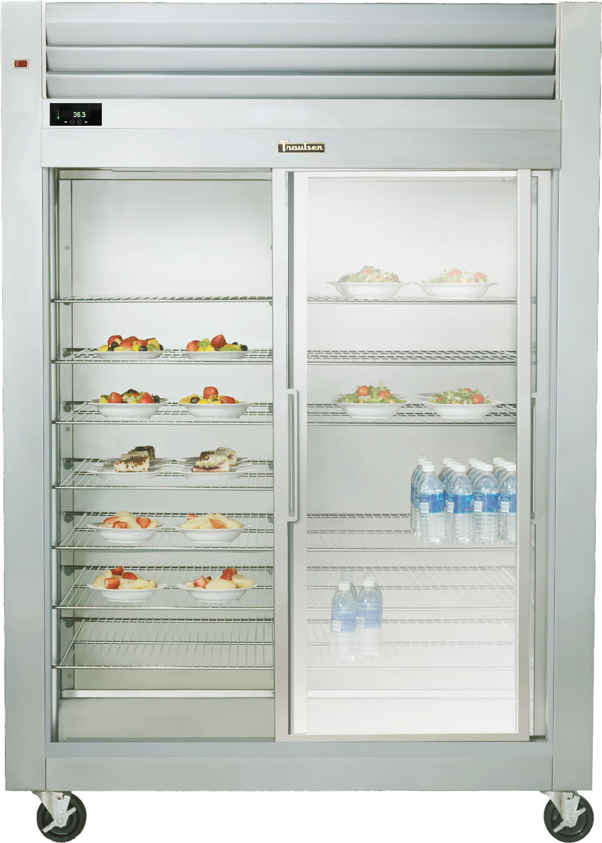 A Spec-Line Reach-in Display refrigerator with sliding glass doors showcases shelves of assorted desserts and fruits on the left, and bottled water on the right. This commercial unit features an electronic temperature display and convenient wheels for mobility.