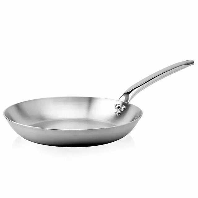A shiny De Buyer Alchimy Saute Pan with a flat base, gently sloped sides, and a long, slightly curved handle attached by three rivets is shown on a white background—the perfect 9.5 inch stainless steel saute pan for everyday cooking.