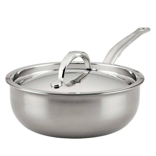 A shiny Hestan Nanobond Saucier pan from JB Prince, 2.0qt, with high sides and a polished stainless steel finish. The long curved handle and matching lid add to its sleek look, reflecting light off their smooth surfaces.