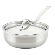 A shiny Hestan Probond Essential Pan, 3.5qt pan, with a long handle and fitted lid featuring a curved top handle. The smooth, reflective stainless steel finish and slightly flared sides stand out against the plain white background.