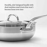 A close-up of the Hestan Probond Essential Pan showcases its chef-designed handle, attached with dual stainless steel rivets that won’t loosen over time. This 3.5qt covered pan features HESTAN engraved on the handle for a premium finish.