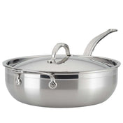 A shiny 28cm stainless steel sauté pan, like the Hestan Probond Essential pan, with a matching domed lid and long curved handle. The wide, flat bottom holds up to 5.0qt, and sturdy metal rivets secure the handle to the body. The lid features a loop handle.