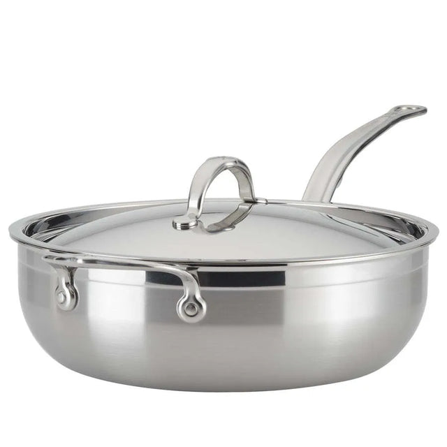 A shiny 28cm stainless steel sauté pan, like the Hestan Probond Essential pan, with a matching domed lid and long curved handle. The wide, flat bottom holds up to 5.0qt, and sturdy metal rivets secure the handle to the body. The lid features a loop handle.