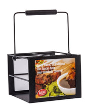 A black metal 4-compartment squeeze bottle caddy with a wooden handle. The side features an ad with sauce-dipped meat, green garnish, “Spicy, Sweet, or Traditional. Our Sauces have your tastebuds covered!” and the TableCraft logo.