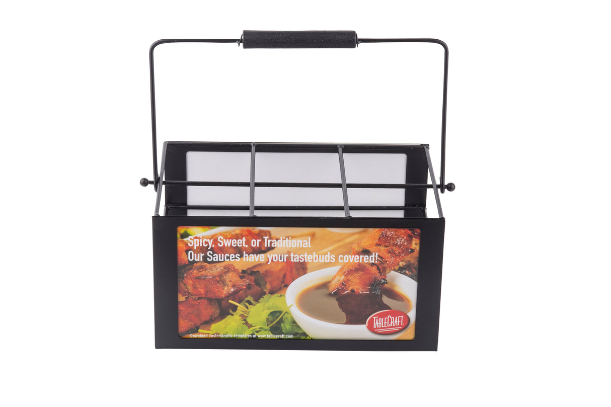A black metal TableCraft Products condiment caddy with a handle, featuring a label showing ribs dipped in sauce and the text Spicy, Sweet, or Traditional. This 6-compartment caddy has your tastebuds covered and neatly holds white napkins inside.