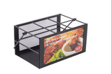 A black metal TableCraft Products squeeze bottle caddy with a rectangular, 6-compartment design features an ad panel showing chicken wings and sauce, promoting spicy, sweet, or traditional sauces. The caddy is empty and set against a white background.