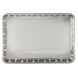 A rectangular stainless steel serving tray with a flat surface and evenly spaced round holes along the raised edges, viewed from above. The smooth, clean surface and metallic finish enhance its appeal. This tray is also dishwasher safe.