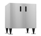 A modern stainless steel cabinet, ideal as an equipment stand, with two vertical doors featuring black rectangular handles. It stands on four tall, black tapered legs with round bases and boasts a minimalistic brushed metal finish.