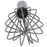 A stainless steel whisk is shown from a top-down angle. Its wire loops fan out in a radial, balloon-like shape, creating symmetry. The shiny French Whip appears clean against a white background.