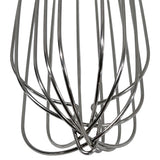 Close-up view of the stainless steel wires of a French Whip, showing shiny, intertwined loops and curves against a white background. The wires are evenly spaced and form a geometric, open structure typical of TableCraft Products.