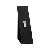 The Dispense-Rite SFL-STAND-1 is a black, upright, rectangular Angled Stand with a metal mounting bracket at its center. Its design features a slightly angled back and flat base to securely support or display items vertically.