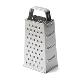 A stainless steel box grater with four sides, each featuring different grating holes. It has a sturdy handle for gripping and stands upright on a flat surface. The shiny, reflective grater is also dishwasher safe for easy cleaning.