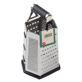 A stainless steel box grater with four sides, each offering different grating surfaces. It has a black plastic handle, a label on one side, and stands upright on a black non-slip base. This box grater is also dishwasher safe for easy cleaning.