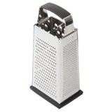This stainless steel box grater features four grating surfaces, a black rubber handle, and a sturdy base. Dishwasher safe for easy cleaning, the grater stands upright against a white background.