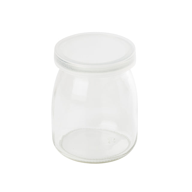 A small, clear, empty glass jar with a wide mouth and a flat, round, transparent lid. The single-serve jar has smooth sides, sits on a white background, and is dishwasher safe. The lid fits snugly on top of the jar.