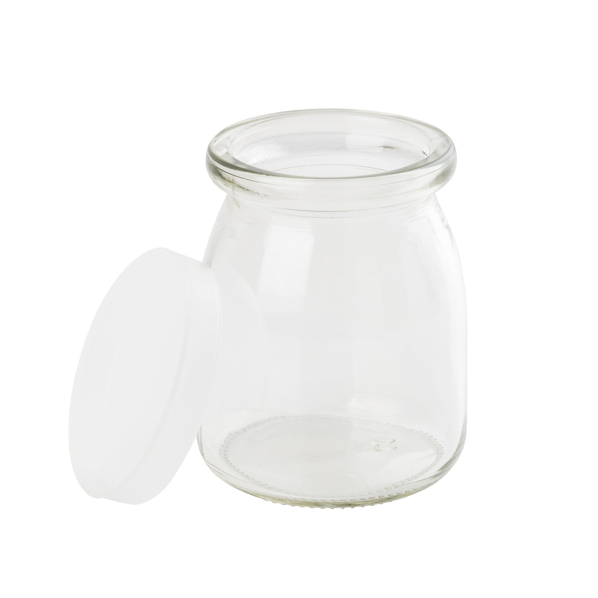 A small, clear glass jar with a wide mouth sits on a white background. The single-serve jar’s white plastic lid is removed and rests against its side. The jar is empty, clean, slightly rounded, and dishwasher safe for easy cleaning.