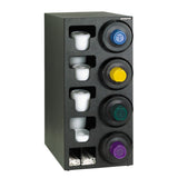 A black polystyrene vertical coffee pod organizer holds five rows of single-serve pods, each with a round opening showing colorful lids. The bottom section stores stir sticks and sugar packets, similar to NSF cup dispensers or a Cup Dispensing Cabinet.