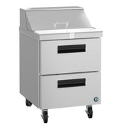 A stainless steel Hoshizaki sandwich top refrigerator with two large black-handled drawers, a hinged top lid, and four caster wheels for mobility. The smooth, reflective surface features a small circular logo on the bottom right corner.