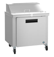 The Hoshizaki SR36B-10 Steelheart Series Sandwich Top Refrigerator features a stainless steel prep table with a flat top, front door handle, four caster wheels, a metal lid covering part of the top, and a temperature gauge on the lower front.