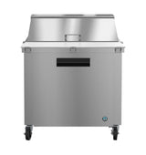 A sleek and modern Hoshizaki Steelheart Series Mega Top Refrigerator features a stainless steel body, flat top, slightly raised back, front-opening door with handle, and four caster wheels. The small circular logo adds a refined touch to this reach-in refrigerator.