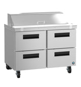 A stainless steel commercial kitchen prep table on wheels, featuring a closed top lid with handle, four pull-out drawers with black handles, and a compact design—ideal for pairing with your reach-in refrigerator for efficient food preparation and storage.