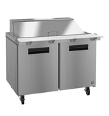 A stainless steel mega top refrigerator with two black-handled doors, a white prep surface, and an angled lid. Four caster wheels provide mobility, making it ideal for use as a sandwich or salad prep station in a professional kitchen.