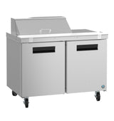 A Hoshizaki Steelheart Series sandwich top refrigerator, this stainless steel commercial prep table features two doors, black handles, four wheels, a flat work surface, a raised back with hinged lid, and a blue circular logo on the lower right corner.