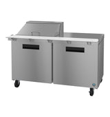 A commercial Hoshizaki Steelheart stainless steel refrigerated prep table with two doors, a raised ingredient rail with lid, white cutting board surface, and four caster wheels. Its sleek, industrial design suits any kitchen.