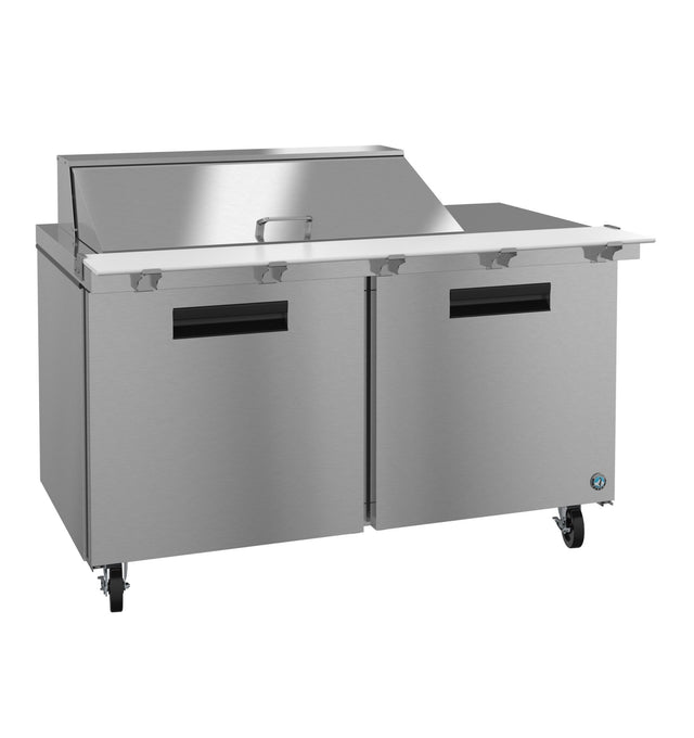A stainless steel mega top refrigerator prep table with two doors, black handles, lockable caster wheels, and a raised covered section on the countertop for ingredient storage and preparation.