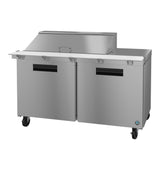 A stainless steel commercial prep table with two black-handled doors, a raised covered section on top, and four caster wheels for mobility; often paired with a mega top refrigerator in restaurant kitchens for food preparation and ingredient storage.