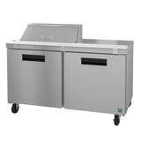 A commercial Hoshizaki Steelheart stainless steel prep table features two doors, black handles, and four wheels. The tabletop includes a raised section with a closed metal lid, ideal for food prep and storage in any professional kitchen.