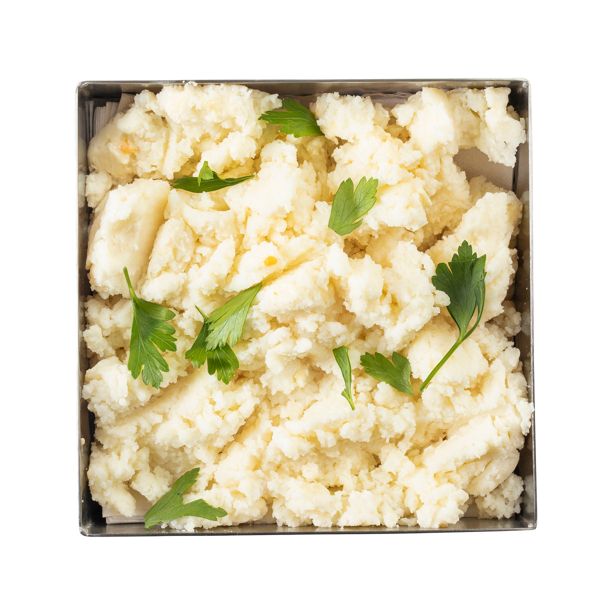 A square stainless steel bowl filled with creamy, fluffy mashed potatoes garnished with fresh parsley leaves. The slightly chunky potatoes are served in a 1-1/4 qt bowl and placed on a white background.