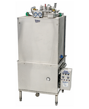 A large industrial stainless steel utensil washer with a boxy, pass through design, control panel on the lower right, pressure gauges and pipes on top, and four sturdy legs—engineered for commercial or industrial use.