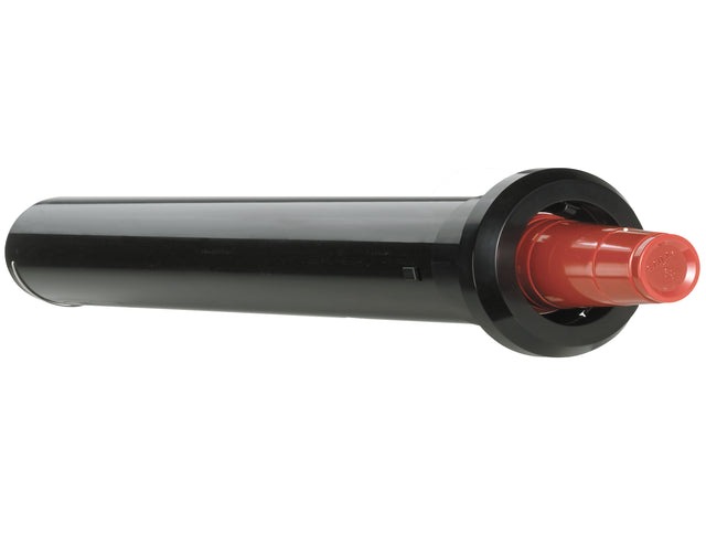 A black cylindrical pop-up lawn sprinkler with a red cap, resembling an in-counter cup dispenser, lies on its side. The glossy finish and raised base stand out against the plain white background, emphasizing the sprinkler’s shape and color.