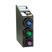 A black coffee organizer with an NSF-certified cup dispenser cabinet holds three rows of coffee pods—purple, green, and blue. On top, compartments keep stir sticks, napkins, sugar packets, and creamers neatly arranged for easy access.