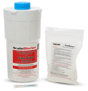 A white cylindrical SCALEBLOCKER Water Filter cartridge with a blue cap stands upright. Beside it is a clear packet for SMF systems labeled Vulcan ScaleRelease containing instructions. A small test strip with colored squares lies in front.