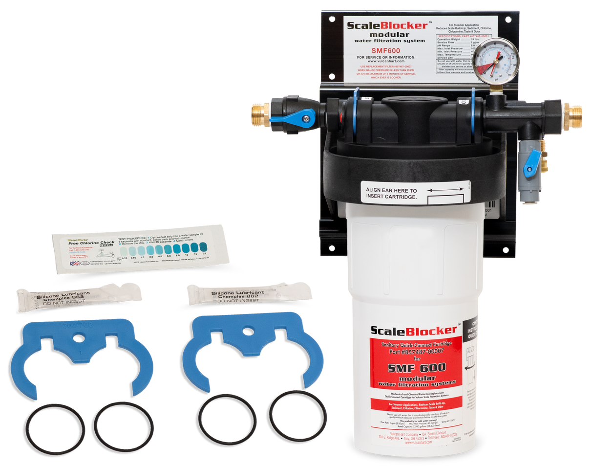 A SCALEBLOCKER™ Water Treatment system, featuring the SMF600-SYSTEM filtration unit with pressure gauge, blue valve, two blue wrench tools, two black O-rings, test strips, and installation instructions—all displayed on a white background.