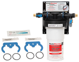 A SCALEBLOCKER™ Water Treatment system, featuring the SMF600-SYSTEM filtration unit with pressure gauge, blue valve, two blue wrench tools, two black O-rings, test strips, and installation instructions—all displayed on a white background.