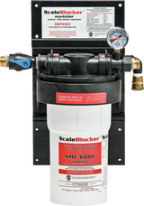 A SCALEBLOCKER™ Water Treatment SMF600-SYSTEM is mounted on a black panel. It features a white cylindrical cartridge, a pressure gauge, labeled connections, and clear red, white, and black Vulcan branding and instructions on the front.