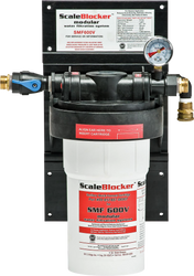 A SCALEBLOCKER™ Water Treatment SMF600-SYSTEM is mounted on a black panel. It features a white cylindrical cartridge, a pressure gauge, labeled connections, and clear red, white, and black Vulcan branding and instructions on the front.