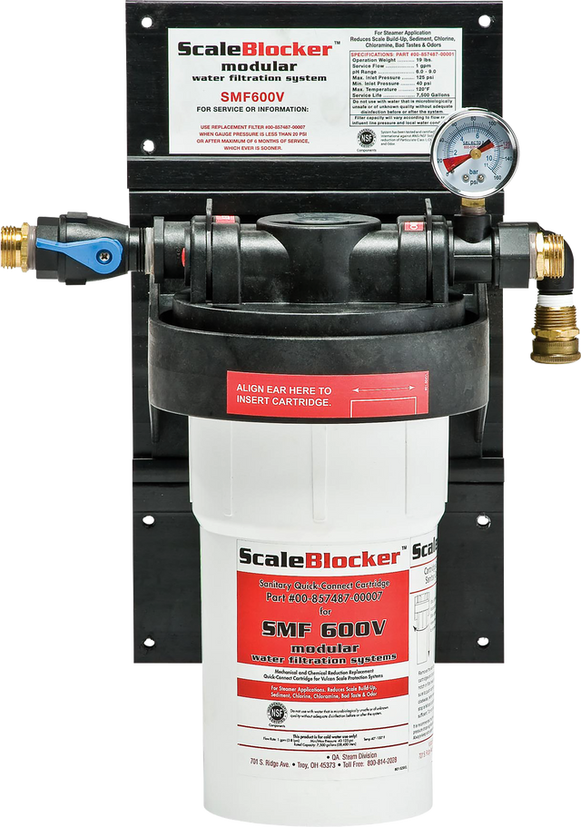 A SCALEBLOCKER™ Water Treatment SMF600-SYSTEM is mounted on a black panel. It features a white cylindrical cartridge, a pressure gauge, labeled connections, and clear red, white, and black Vulcan branding and instructions on the front.