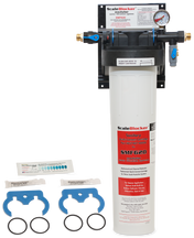 A Vulcan SMF620 SCALEBLOCKER Water Treatment System is mounted on the wall. Below, replacement parts include two blue wrenches, two black O-rings, and two small packets. The white filter housing features a pressure gauge and product labeling.