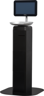 A black, rectangular self-serve kiosk with a wide base, a touchscreen monitor mounted on top, and a metallic tray below the screen—resembling the modern, minimalistic design of the Hobart FS-100 FreshServe Scale. The screen is off and blank.