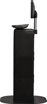 A side view of a black Self-Serve Scale kiosk with a flat base, vertical rectangular body, angled touchscreen display at the top, and a small tray below the screen. The kiosk stands alone on a circular platform.