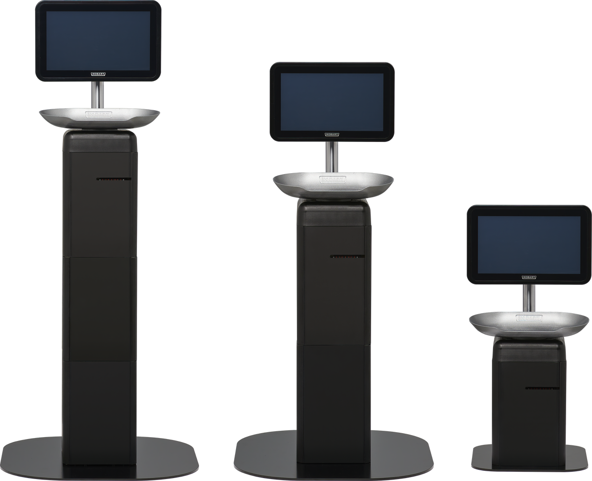 Three black Hobart FS-2BV touchscreen scale kiosks of varying heights stand on black bases against a white background. Each self-serve scale features a rectangular display and a metallic tray or shelf below for seamless user interaction.