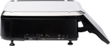 A side view of a black and white projector with its back panel facing forward, showing various ports including USB, HDMI, VGA, audio, Ethernet, and a 7 customer display. The device sits on two small legs with a gray angled cover partially open on the right side.