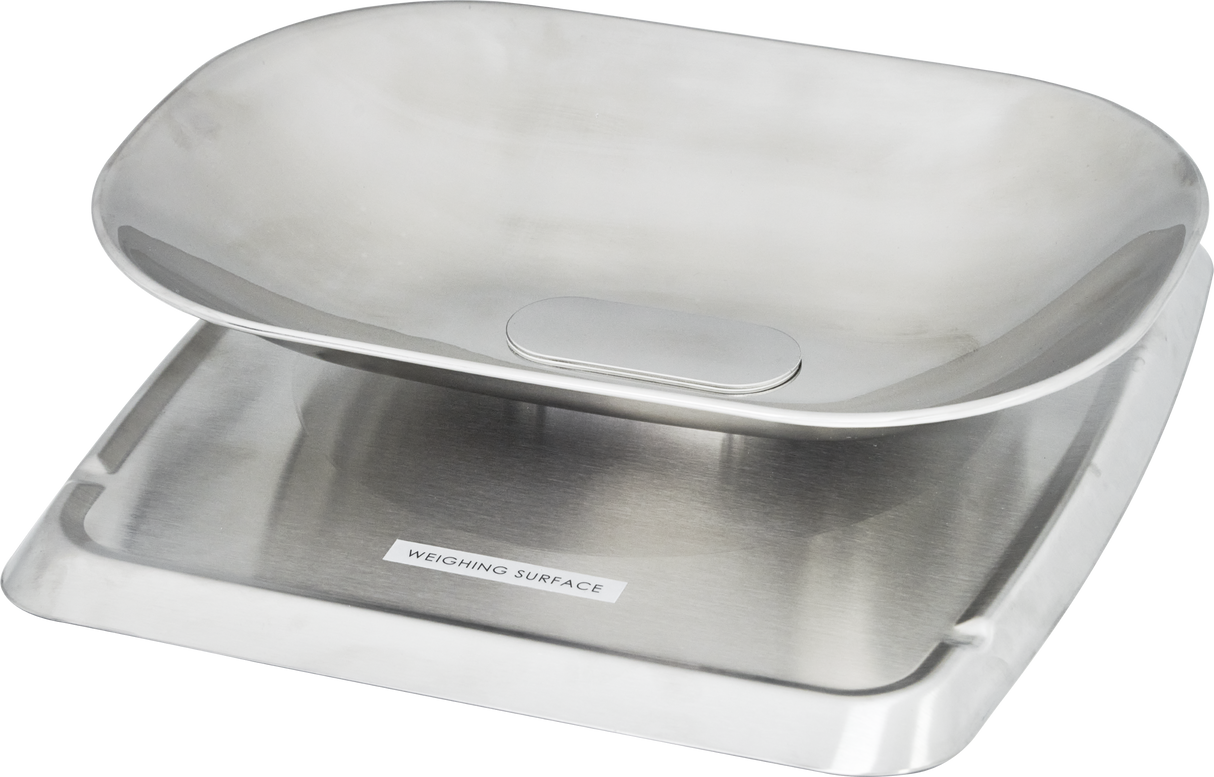 A sleek, minimalist Hobart self-serve scale with a brushed stainless steel finish and a shallow oval weighing dish on top. The flat base is clearly labeled “WEIGHING SURFACE,” making it ideal for kitchens or laboratories.