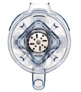 Top-down view of an empty, transparent Vitamix blender jar featuring the Aer Blend Disc Assembly with four angled blades at the base and a central metal component; handle is visible at the bottom, and the jar has a slightly blue tint.